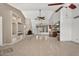 Spacious living room features a stone fireplace, built-in shelves, and neutral tile flooring at 9839 W Utopia Rd, Peoria, AZ 85382