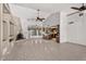 Open-concept living room boasts a stone fireplace, built-in shelves, and tile flooring at 9839 W Utopia Rd, Peoria, AZ 85382