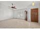 Bright living room featuring neutral paint, tile floors, large windows, and a grandfather clock at 9839 W Utopia Rd, Peoria, AZ 85382