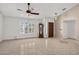 Bright living room featuring neutral paint, tile floors, large windows, and a grandfather clock at 9839 W Utopia Rd, Peoria, AZ 85382
