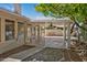 Large covered patio with ceiling fan and landscaped backyard, perfect for entertaining or relaxing outdoors at 9839 W Utopia Rd, Peoria, AZ 85382