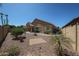 Backyard showcasing desert landscaping, low-maintenance ground cover, and a view of the home's exterior at 10465 E Knowles Ave, Mesa, AZ 85209