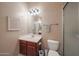 Half bathroom with a vanity, mirror, towel rack, toilet, and glass-enclosed shower at 10465 E Knowles Ave, Mesa, AZ 85209