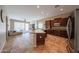 Open kitchen featuring a central island, stainless steel appliances, and seamless flow into living area at 10465 E Knowles Ave, Mesa, AZ 85209