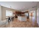 Open-concept kitchen and dining area featuring a breakfast bar and stainless steel appliances at 10465 E Knowles Ave, Mesa, AZ 85209