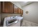 Laundry room featuring cabinets above a white, front-load washer and dryer set at 10465 E Knowles Ave, Mesa, AZ 85209