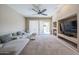 Comfortable living room featuring a plush sofa, a built-in entertainment unit, and sliding glass doors at 10465 E Knowles Ave, Mesa, AZ 85209
