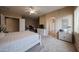Spacious main bedroom with a large bed, ceiling fan, and view of a walk-in closet and the Primary bath at 10465 E Knowles Ave, Mesa, AZ 85209