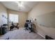 Office with two desks, monitors, a whiteboard, workout equipment, and a ceiling fan at 10465 E Knowles Ave, Mesa, AZ 85209