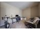 View of the office that includes a desk, chair, loveseat, and workout equipment at 10465 E Knowles Ave, Mesa, AZ 85209
