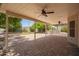 The spacious covered patio features dual ceiling fans, stone pavers, an outdoor fire pit, and built-in grill at 1063 W Vaughn St, Tempe, AZ 85283