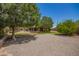 Beautiful backyard showcasing a lawn, mature shade trees, and an outdoor kitchen area for entertaining at 1063 W Vaughn St, Tempe, AZ 85283
