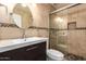 Bathroom featuring a vanity, a frameless glass walk-in shower, updated fixtures, and tile flooring at 1063 W Vaughn St, Tempe, AZ 85283