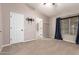 Neutral bedroom offers vaulted ceilings, carpet, a large window, closet and ensuite access, and a TV mount at 1063 W Vaughn St, Tempe, AZ 85283
