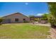 Exterior view of home with an outdoor kitchen, spacious yard and covered patio area at 1063 W Vaughn St, Tempe, AZ 85283
