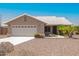 Charming single-story home with a two-car garage, desert landscaping and a light tile roof at 1063 W Vaughn St, Tempe, AZ 85283