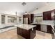 Eat-in kitchen features a large island, stainless appliances, granite counters, tiled backsplash, and a breakfast nook at 1063 W Vaughn St, Tempe, AZ 85283