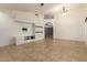 A spacious living room featuring light tile floors, modern built-ins, and neutral wall paint at 1063 W Vaughn St, Tempe, AZ 85283