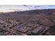 Scenic aerial shot of a desert neighborhood near mountains, pinpointing the home's location at twilight at 1123 W Thunderhill Dr, Phoenix, AZ 85045