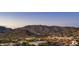 Enjoy a lovely aerial view of the neighborhood, retail areas, and a scenic mountain backdrop at 1123 W Thunderhill Dr, Phoenix, AZ 85045