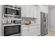 Stainless steel appliances including a microwave, oven, and refrigerator with white cabinets at 1123 W Thunderhill Dr, Phoenix, AZ 85045