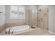 Luxurious bathroom with a soaking tub and a glass-enclosed shower at 1123 W Thunderhill Dr, Phoenix, AZ 85045