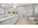 Bathroom featuring double sinks, granite countertop, large mirror and a soaking tub at 1123 W Thunderhill Dr, Phoenix, AZ 85045
