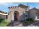 Exterior shot featuring an arched entry with a brick walkway and flower bed with yellow flowers at 1123 W Thunderhill Dr, Phoenix, AZ 85045