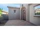 Front door view with brick pavers, welcome mat, and neutral stucco walls at 1123 W Thunderhill Dr, Phoenix, AZ 85045