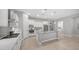Open concept kitchen with island, stainless appliances, white cabinets and tile floors at 1123 W Thunderhill Dr, Phoenix, AZ 85045