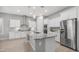 Spacious kitchen with a large island, granite countertops, stainless steel appliances, and white cabinets at 1123 W Thunderhill Dr, Phoenix, AZ 85045