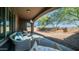 Relaxing covered patio overlooks a gravel backyard with mature trees at 1123 W Thunderhill Dr, Phoenix, AZ 85045