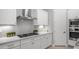 Modern gas stovetop with stainless steel vent hood and white cabinets at 1123 W Thunderhill Dr, Phoenix, AZ 85045