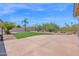 Expansive backyard featuring green turf, desert landscaping and a large concrete patio at 11306 E Rembrandt Ave, Mesa, AZ 85212