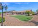 Lush backyard with a well-maintained lawn, desert landscape, and outdoor seating area at 11306 E Rembrandt Ave, Mesa, AZ 85212