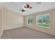 Bright bedroom features two large windows and a ceiling fan for optimal comfort at 11306 E Rembrandt Ave, Mesa, AZ 85212