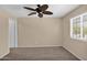 Bedroom featuring ceiling fan and window with coverings at 11306 E Rembrandt Ave, Mesa, AZ 85212