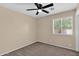 Bedroom with ceiling fan and window with view to backyard at 11306 E Rembrandt Ave, Mesa, AZ 85212