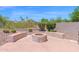 Backyard with a built-in fire pit, seating, and desert landscaping at 11306 E Rembrandt Ave, Mesa, AZ 85212