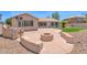Cozy backyard featuring a fire pit with built-in seating perfect for outdoor gatherings at 11306 E Rembrandt Ave, Mesa, AZ 85212