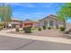 Inviting single-story home with manicured desert landscaping and vibrant red garage door at 11306 E Rembrandt Ave, Mesa, AZ 85212