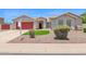 Charming single-story home featuring a red garage door and desert landscaping at 11306 E Rembrandt Ave, Mesa, AZ 85212