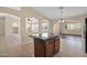 Eat-in kitchen island with granite countertops and dark wood cabinets at 11306 E Rembrandt Ave, Mesa, AZ 85212