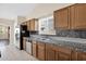 Kitchen features stainless steel appliances, granite countertops and wood cabinets at 11306 E Rembrandt Ave, Mesa, AZ 85212