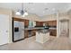 Well-lit kitchen features tile floors, granite countertops and stainless steel appliances at 11306 E Rembrandt Ave, Mesa, AZ 85212
