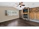 Living room featuring hardwood floors and fireplace with stone surround at 11306 E Rembrandt Ave, Mesa, AZ 85212