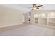 Spacious living room featuring tile flooring, a ceiling fan, and open access to the kitchen at 11306 E Rembrandt Ave, Mesa, AZ 85212