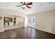 Open concept living room with hardwood floors, with view of kitchen and french doors to the backyard at 11306 E Rembrandt Ave, Mesa, AZ 85212
