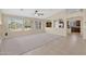 Spacious living room with tile floors, large windows, and open floor plan at 11306 E Rembrandt Ave, Mesa, AZ 85212