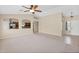 Open-concept living room with tile floors, ceiling fan, and arched doorways at 11306 E Rembrandt Ave, Mesa, AZ 85212